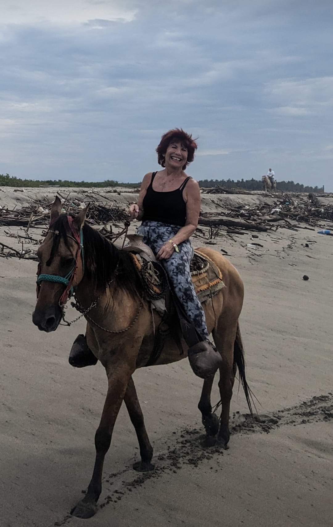 Linda horseback riding on the beach